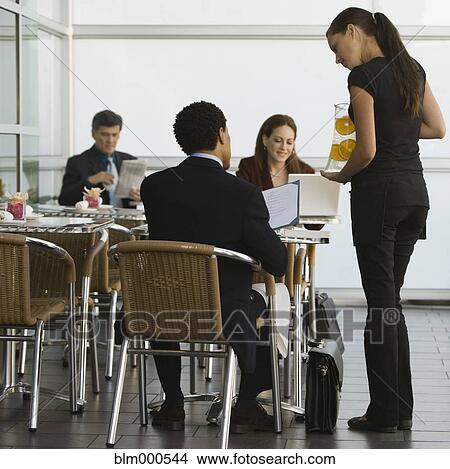 Picture - Waitress taking businessmanÆs order. Fotosearch