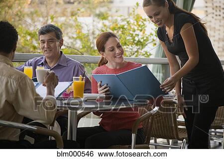 Waitress taking womanÆs order in restaurant View Large Photo Image Stock Photograph - Waitress taking womanÆs order in restaurant. Fotosearch