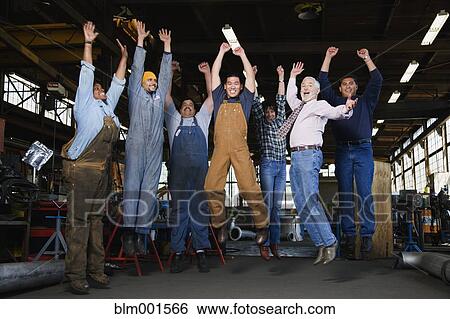 Warehouse workers jumping in warehouse View Large Photo Image Stock Photograph - Warehouse workers jumping in warehouse. Fotosearch