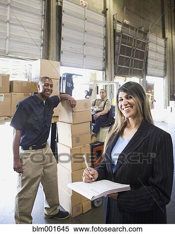 Stock Photography - Warehouse workers with boxes and forklift. Fotosearch