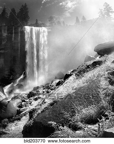 Stock Image - Waterfall and rocky hillside, Yosemite, California, United States. Fotosearch