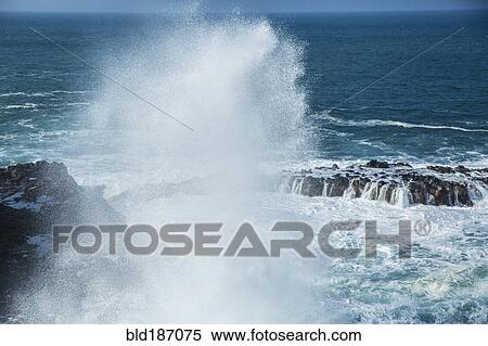 Stock Photography - Waves crashing on rocky beach. Fotosearch