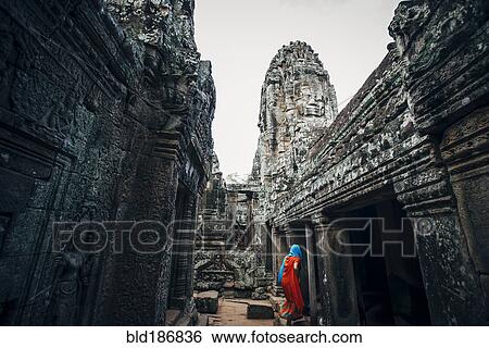 Stock Photograph - Woman exploring ruins at Angkor Wat, Siem Reap, Cambodia. Fotosearch
