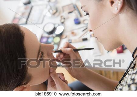 Woman having makeup applied by stylist View Large Photo Image Stock Image - Woman having makeup applied by stylist. Fotosearch