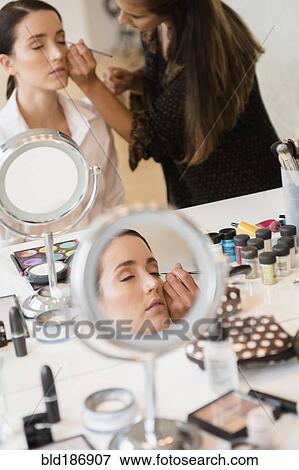 Stock Photo - Woman having makeup applied by stylist. Fotosearch
