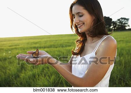 Woman holding butterfly in hands View Large Photo Image Stock Photo - Woman holding butterfly in hands. Fotosearch