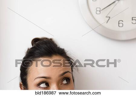 Woman looking at clock View Large Photo Image Stock Photo - Woman looking at clock. Fotosearch