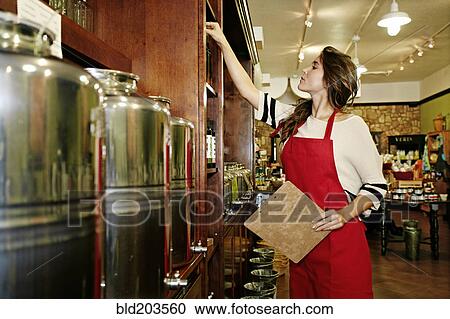 Stock Image - Woman working in grocery store. Fotosearch