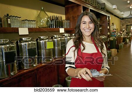Woman working in grocery store View Large Photo Image Stock Photo - Woman working in grocery store. Fotosearch