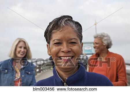 Stock Photograph - Women standing on pier. Fotosearch