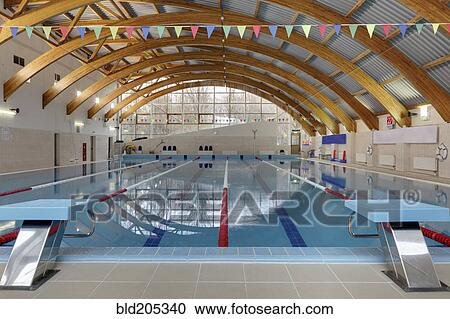 Stock Image - Wooden arches over swimming pool. Fotosearch