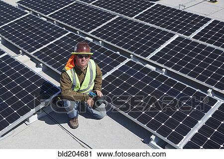 Worker sitting with solar panels outdoors View Large Photo Image Stock Image - Worker sitting with solar panels outdoors. Fotosearch