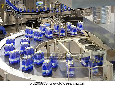 Stock Image - Wrapped bottles on production line in bottling plant. Fotosearch