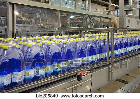 Stock Photo - Wrapped bottles on production line in bottling plant. Fotosearch
