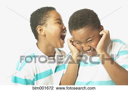 Young African boy yelling into twin brother's ear View Large Photo Image Stock Image - Young African boy yelling into twin brother's ear. Fotosearch