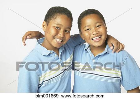 Stock Photo - Young African twin brothers hugging and smiling. Fotosearch