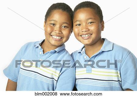 Young African twin brothers hugging and smiling View Large Photo Image Stock Photo - Young African twin brothers hugging and smiling. Fotosearch