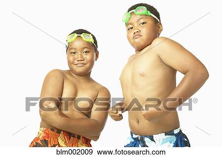 Stock Photo - Young African twin brothers in bathing suits flexing. Fotosearch