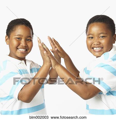 Stock Image - Young African twin brothers smiling. Fotosearch