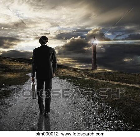 Young businessman on path towards lighthouse View Large Photo Image Stock Image - Young businessman on path towards lighthouse. Fotosearch