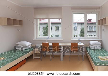 A dormitory bedroom with beds and bed linen View Large Photo Image Picture - A dormitory bedroom with beds and bed linen. Fotosearch