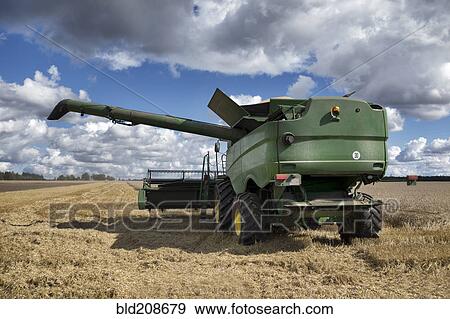 A large combine harvester machinery cutting the ripe arable crop View Large Photo Image Stock Photo - A large combine harvester machinery cutting the ripe arable crop. Fotosearch