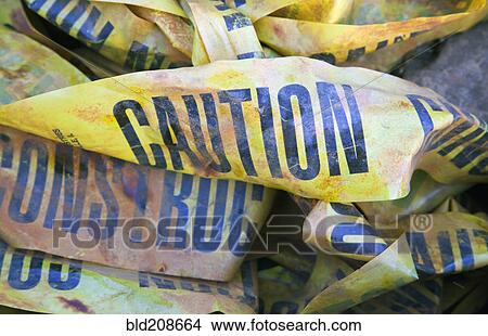 Picture - A pile of discarded Caution Construction warning printed tapes. Fotosearch