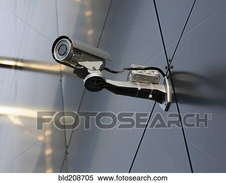 A security camera mounted on the wall of a building View Large Photo Image Stock Photography - A security camera mounted on the wall of a building. Fotosearch