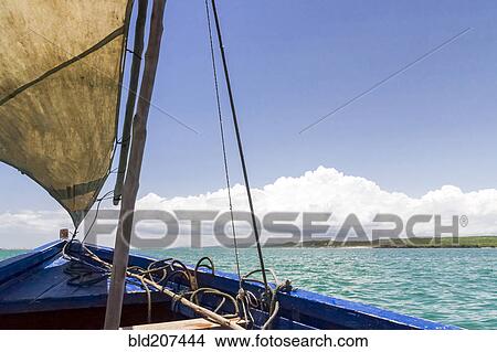 A traditional fishing boat in the emerald sea of Antsiranana View Large Photo Image Picture - A traditional fishing boat in the emerald sea of Antsiranana. Fotosearch