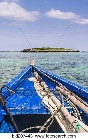 Stock Image - A traditional fishing boat in the emerald sea of Antsiranana. Fotosearch