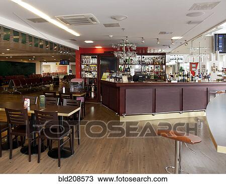 Stock Image - A well stocked bar with seats in the departure lounge. Fotosearch