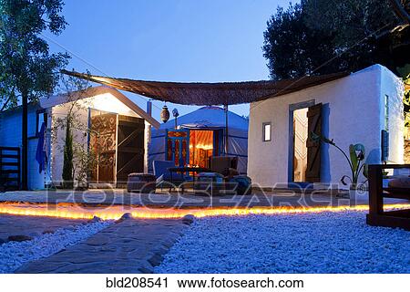 Stock Image - Accommodation at a holiday resort with two cabins and a Mongolian Yurt. Fotosearch