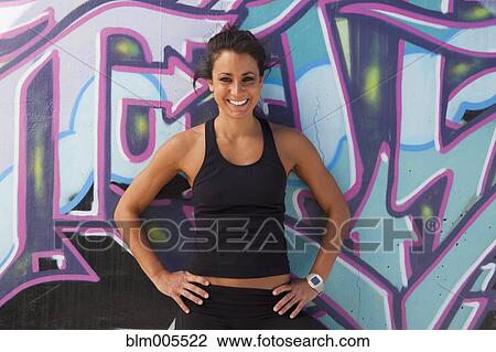 Active Cuban woman standing near graffiti on wall View Large Photo Image Stock Image - Active Cuban woman standing near graffiti on wall. Fotosearch
