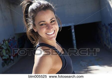 Stock Photography - Active Cuban woman standing near aqueduct. Fotosearch