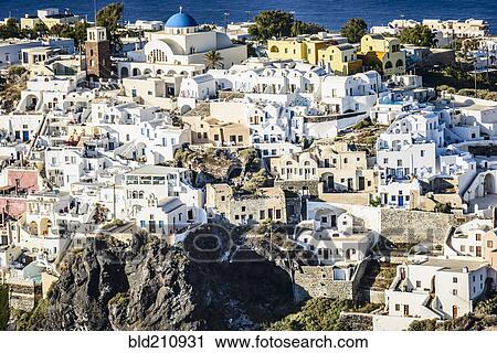 Stock Image - Aerial view of city built on hilltop, Santorini, Egeo, Greece. Fotosearch