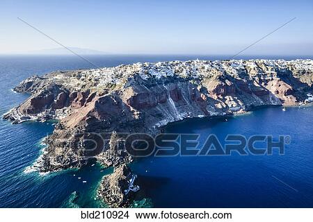 Picture - Aerial view of city built on rocky coastline, Oia, Egeo, Greece. Fotosearch