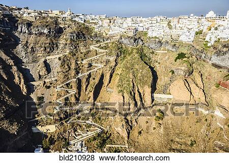 Stock Photo - Aerial view of city built on rocky hilltop, Oia, Egeo, Greece. Fotosearch