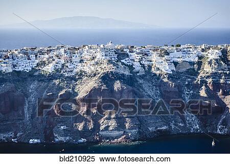 Stock Photography - Aerial view of city built on rocky coastline, Oia, Egeo, Greece. Fotosearch