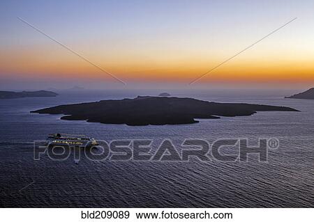 Stock Photo - Aerial view of cruise ship sailing in ocean at sunset, Santorini, Greece. Fotosearch