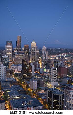 Stock Image - Aerial view of Seattle skyline lit up at night, Washington, United States. Fotosearch