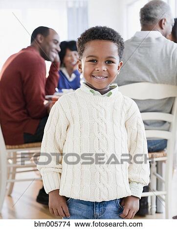 African American boy smiling with family in background View Large Photo Image Picture - African American boy smiling with family in background. Fotosearch