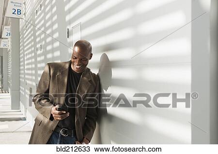 African American businessman using cell phone in office View Large Photo Image Stock Image - African American businessman using cell phone in office. Fotosearch