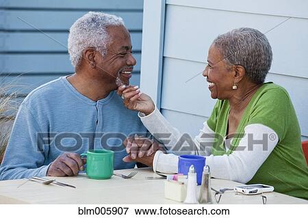 African American couple holding hands in cafe View Large Photo Image Stock Photo - African American couple holding hands in cafe. Fotosearch