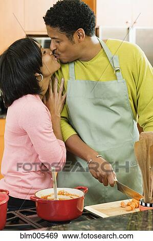 African American couple kissing in kitchen View Large Photo Image Stock Photo - African American couple kissing in kitchen. Fotosearch