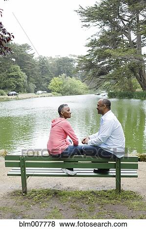 African American couple sitting on bench near lake View Large Photo Image Stock Photo - African American couple sitting on bench near lake. Fotosearch
