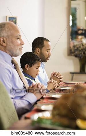 African American family saying grace at dinner table View Large Photo Image Stock Image - African American family saying grace at dinner table. Fotosearch