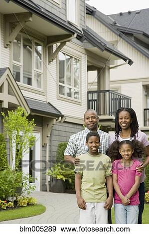 Stock Photo - African American family standing outside house. Fotosearch