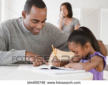 African American father helping daughter with homework View Large Photo Image Stock Photo - African American father helping daughter with homework. Fotosearch