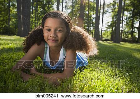 African American girl laying in grass View Large Photo Image Stock Image - African American girl laying in grass. Fotosearch
