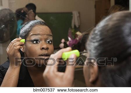African American girl putting on mascara backstage View Large Photo Image Stock Photo - African American girl putting on mascara backstage. Fotosearch